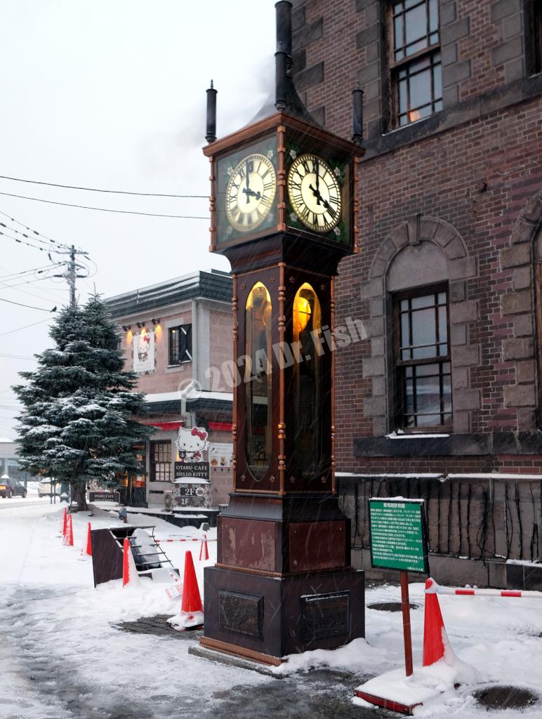 steam clock in front of main building of music box museum on sakaimachi street